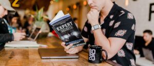 Man reading book on expert secrets